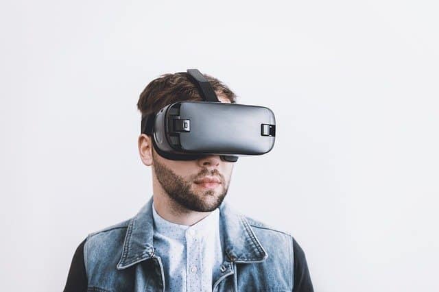 Virtual reality user wearing a VR headset, exploring immersive digital environments, modern technology, virtual reality experience, innovative entertainment.