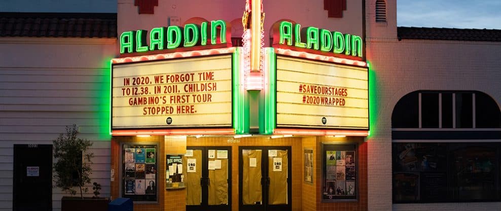 Aladdin Theatre marquee with neon lights and historical movie posters, showcasing music and entertainment venue in Hollywood, Los Angeles.