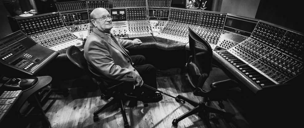 Highly detailed professional audio mixing console in a recording studio with a sound engineer, capturing the essence of music production and sound engineering.