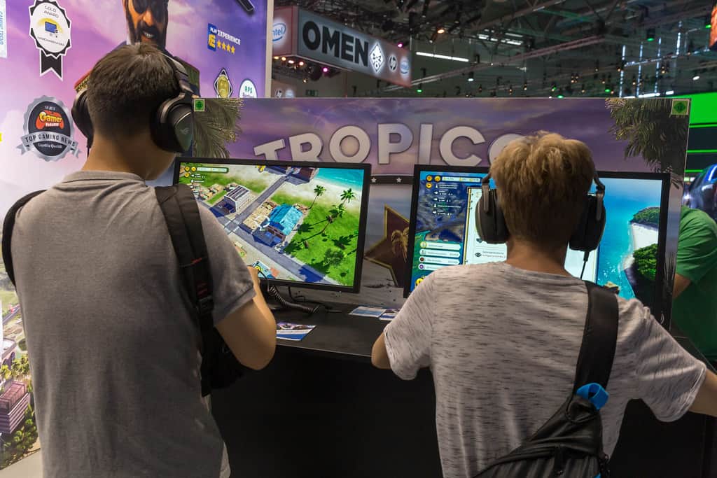 Young gamers playing immersive video games at a gaming expo, showcasing innovative gaming technology and entertainment.