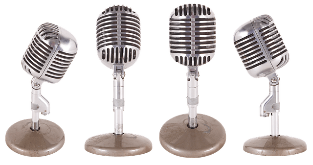 Vintage microphones on a stand, used for radio broadcasting and music performances, representing audio technology and live sound recording.