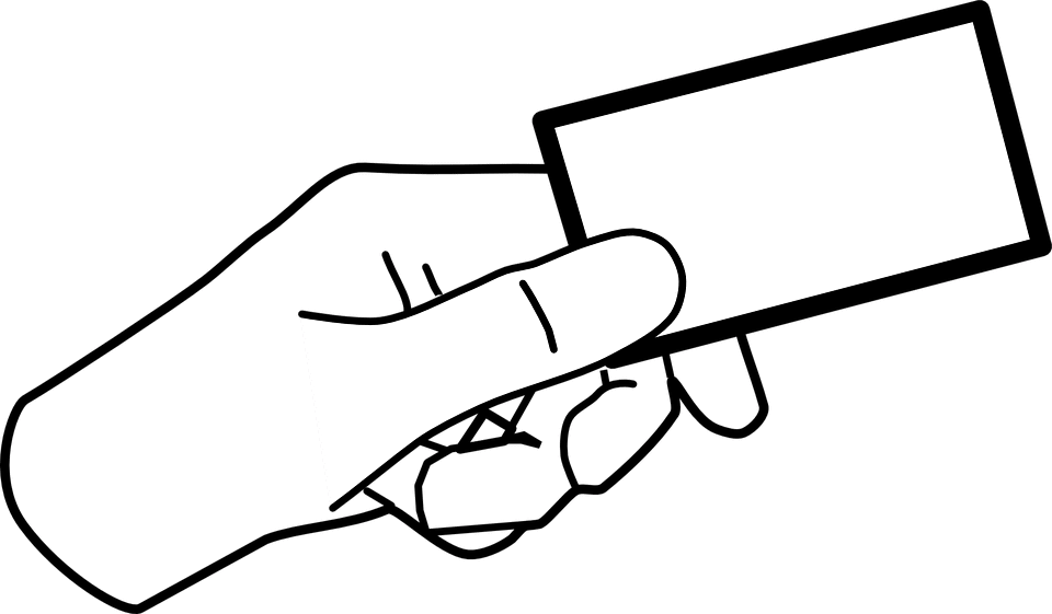 Mobile phone hand holding blank credit card for contactless payment.
