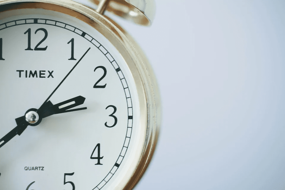 Timex alarm clock close-up, minimalistic design, vintage-style timepiece, classic analog clock, home decor and functionality, Hypebot feature image.