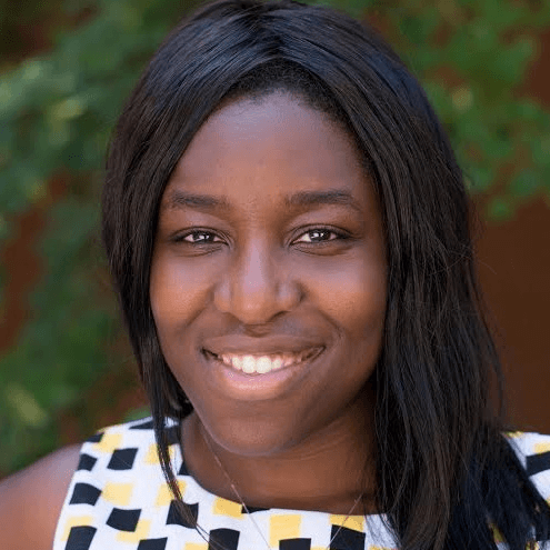 A professional woman smiling outdoors with a blurred green background, representing music industry insights, media innovation, and digital trends, ideal for Hypebot's music business and media coverage topics.