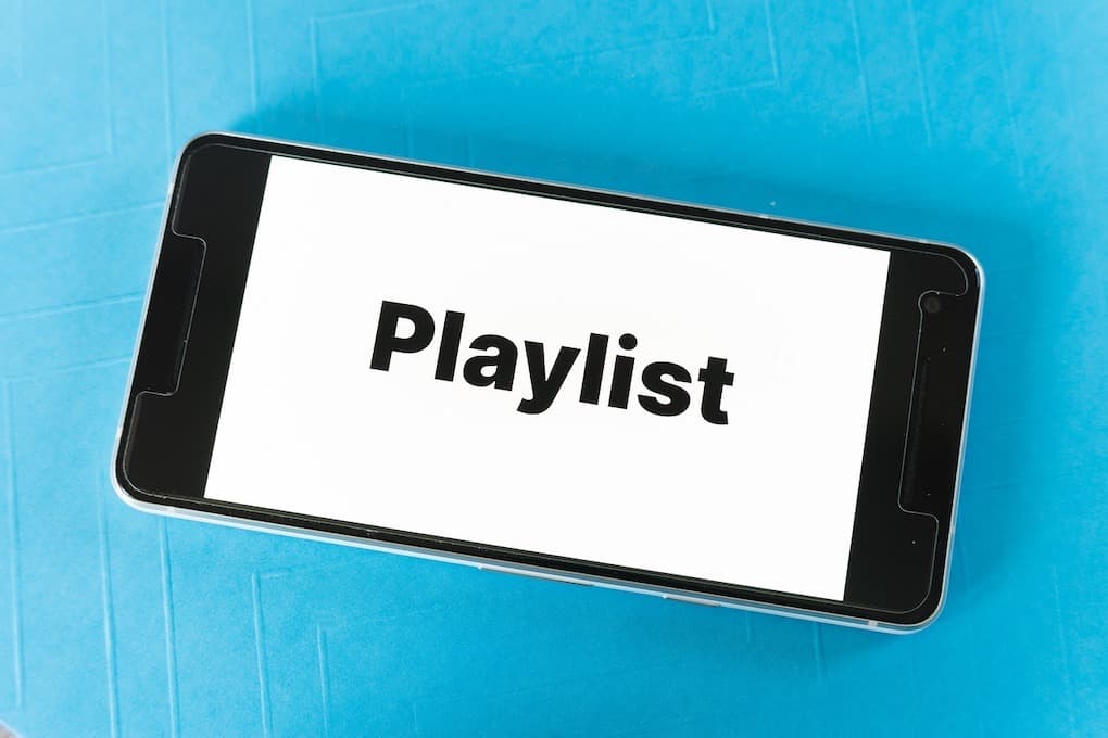 Playlist on a smartphone screen for music streaming or digital playlists, concept of music curation and playlist management.