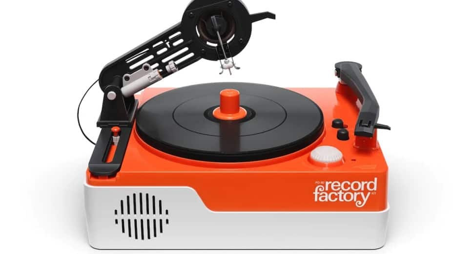 Record factory turntable toy for music editing and DJ mixing, vibrant orange and white design, vintage style record player with stylus arm and controls, fun musical instrument for kids and adults, nostalgic music gear.