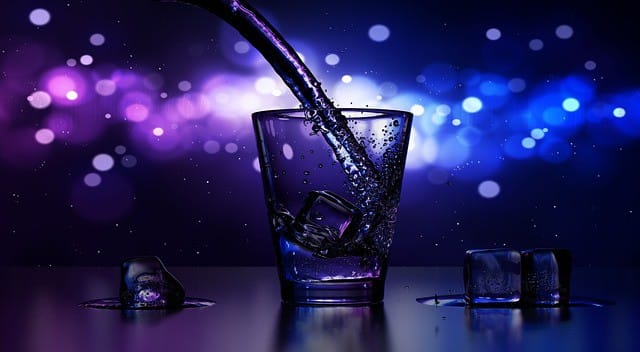Bright blue and purple bokeh background with ice cubes in a glass of water, featuring a splash effect and reflections, creating a vibrant, refreshing, and lively atmosphere.