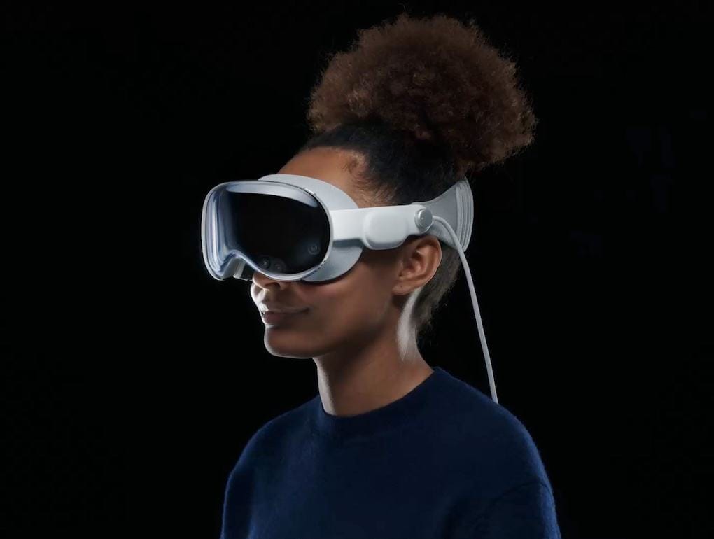 Virtual reality headset worn by a woman with natural hair styled in an updo, showcasing immersive technology.