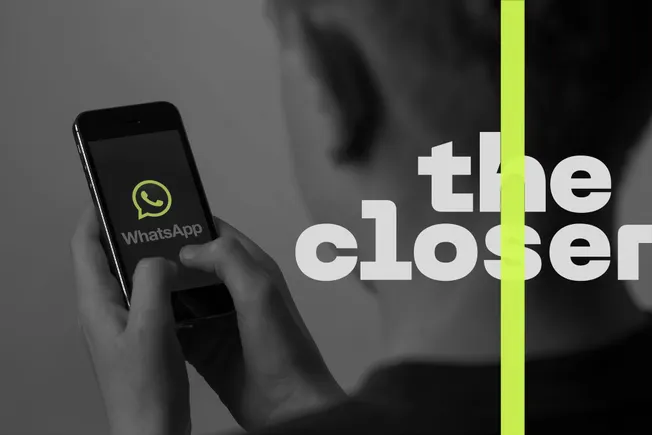WhatsApp logo on a phone in someone's hand, with The Closer logo