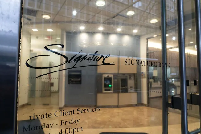 Signature Bank branch entrance seen through glass doors