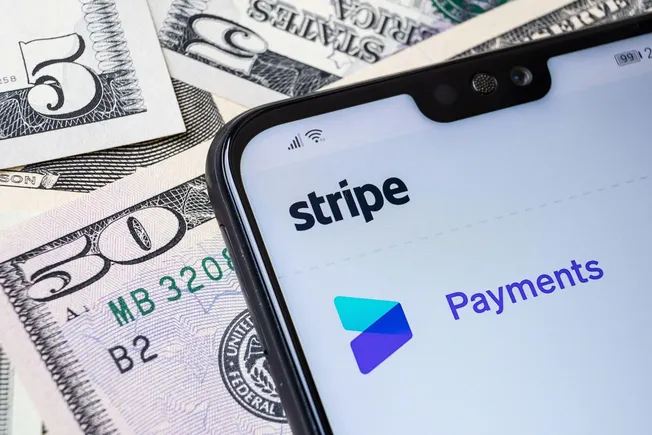 Stripe Payments on a phone lying on US dollar bills