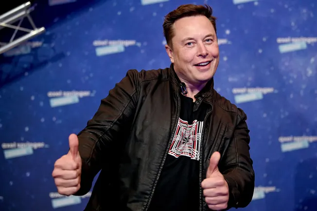Elon Musk giving two thumbs up at an event