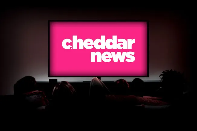 Cheddar News logo on a screen in a dark cinema