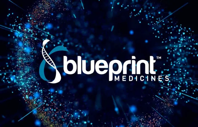 Blueprint Medicines logo on a dark blue particle background