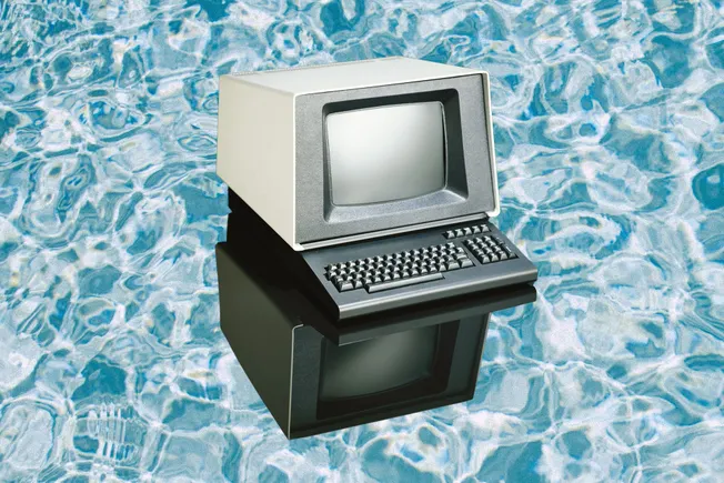Vintage computer floating in a swimming pool
