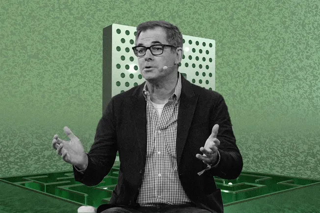 Tech executive gesturing in front of a green server-rack collage