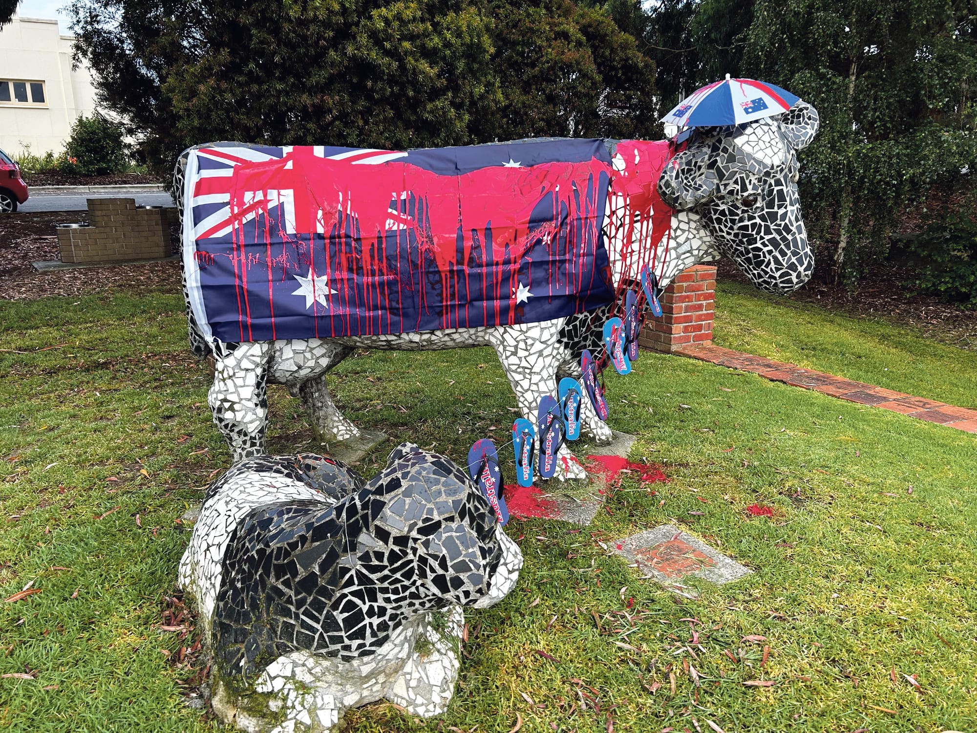 Local cow statue butchered by red paint