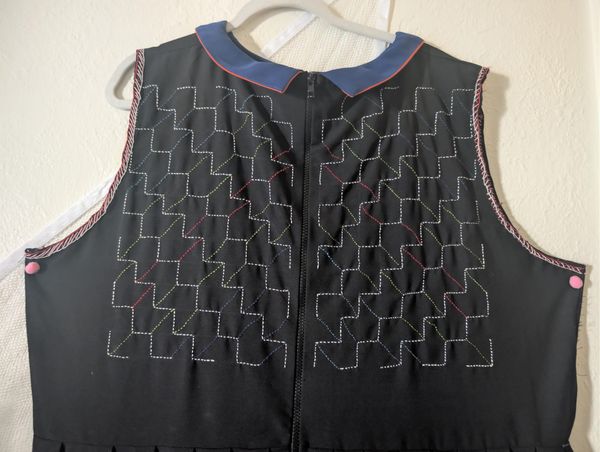 two back panels of yabane (arrow) which is a sashiko moyǒzashi pattern. the pattern is made with white, red, blue, light green.