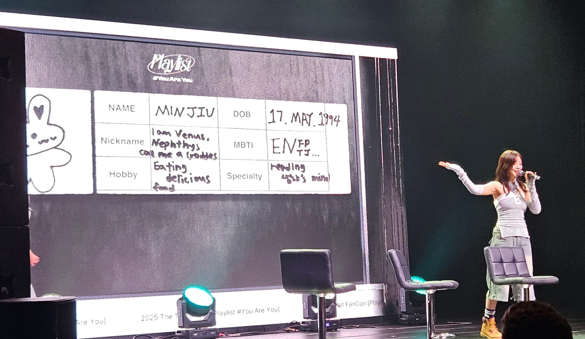 JiU presenting a slide on the screen that shows a profile she filled out for herself.