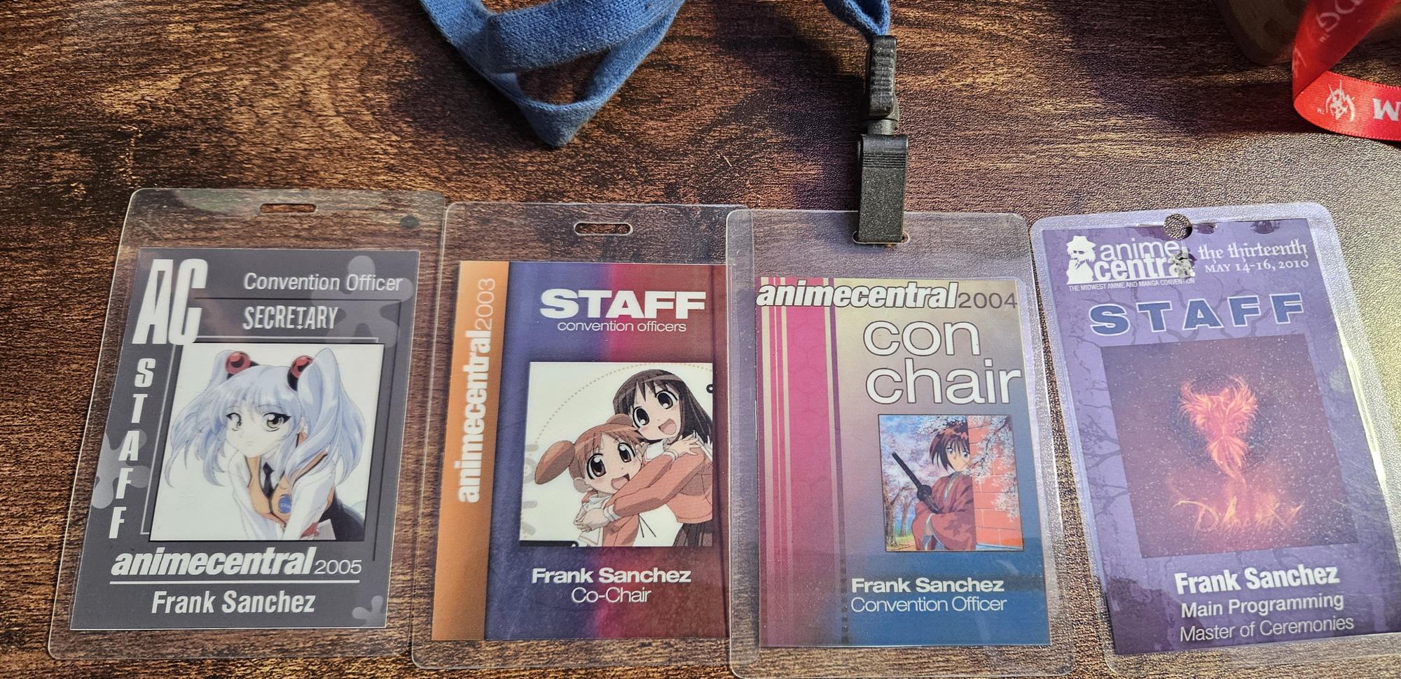 Picture of 4 Anime Central staff badges I owned, where I served as a Convention Chair, Convention Officer, and Master of Ceremonies, among other things.