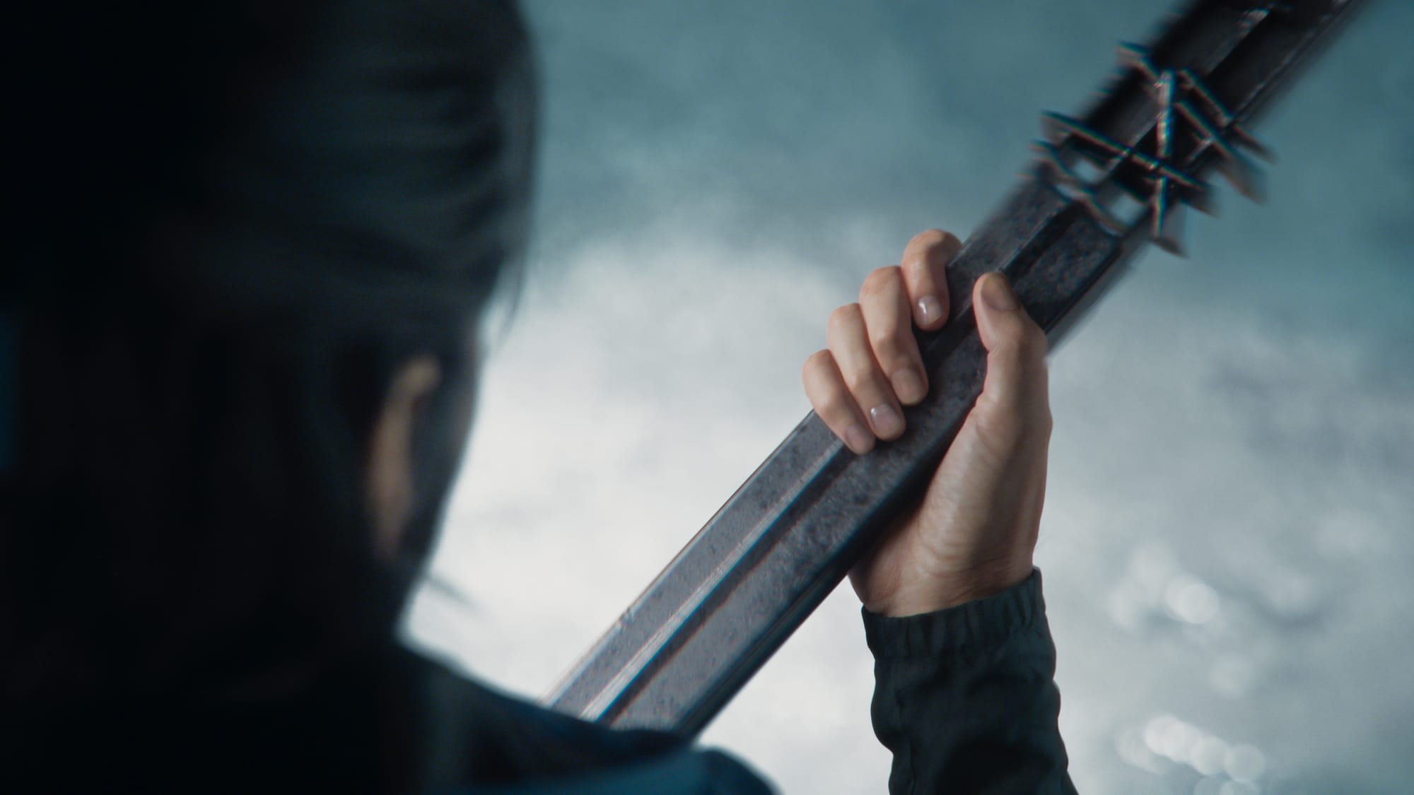 A close up shot focuses on Dylan holding a piece of metallic rebar, the Aberrant, that seems to shake and shift in his hands.