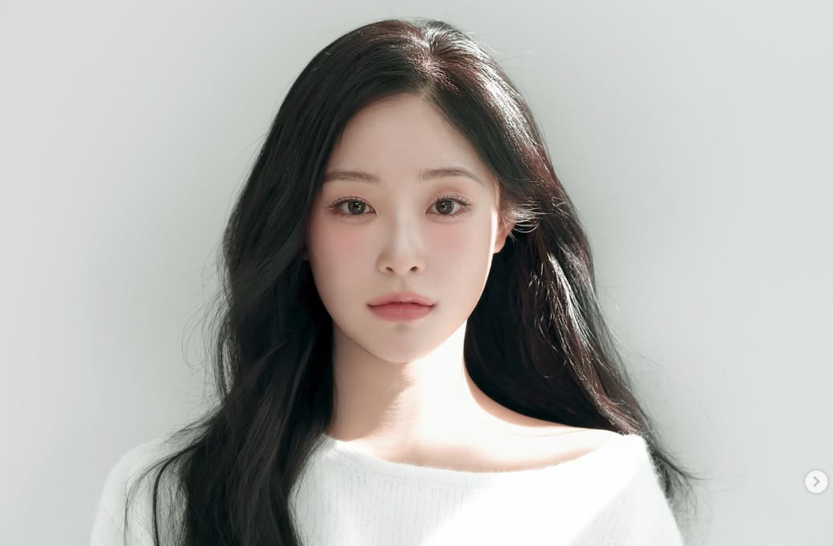 Dreamcatcher Gahyun looking at the camera in a white sweater.