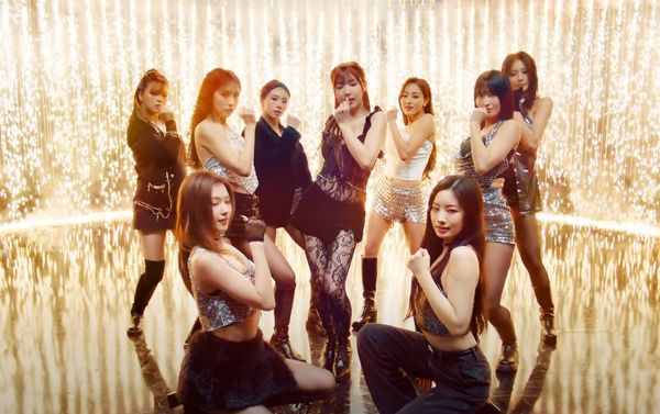 TWICE with golden sparkling fireworks in the background, ends their dance routine for "ONE SPARK"