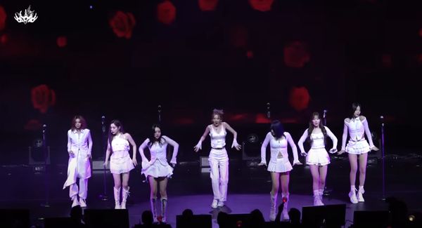 Dreamcatcher in white performing on stage in New York City.
