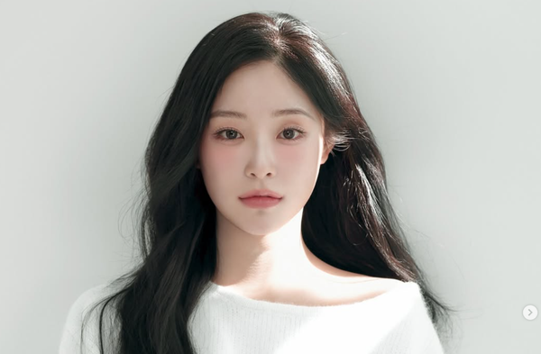 Dreamcatcher Gahyun looking at the camera in a white sweater.