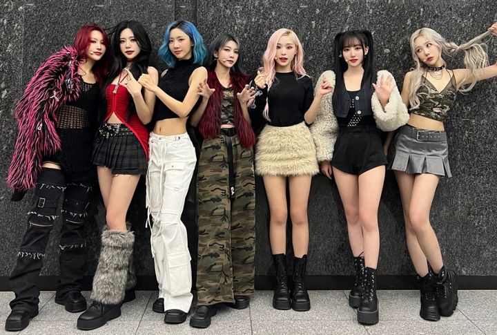 Dreamcatcher in fashionable clothes posing on a dark background for a music show in December.