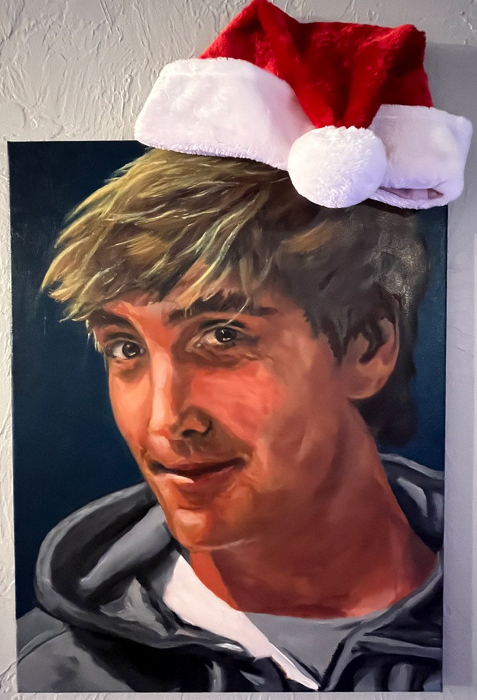 oil painting of candide thovex with an actual santa cap cheekily nailed on top of the painting