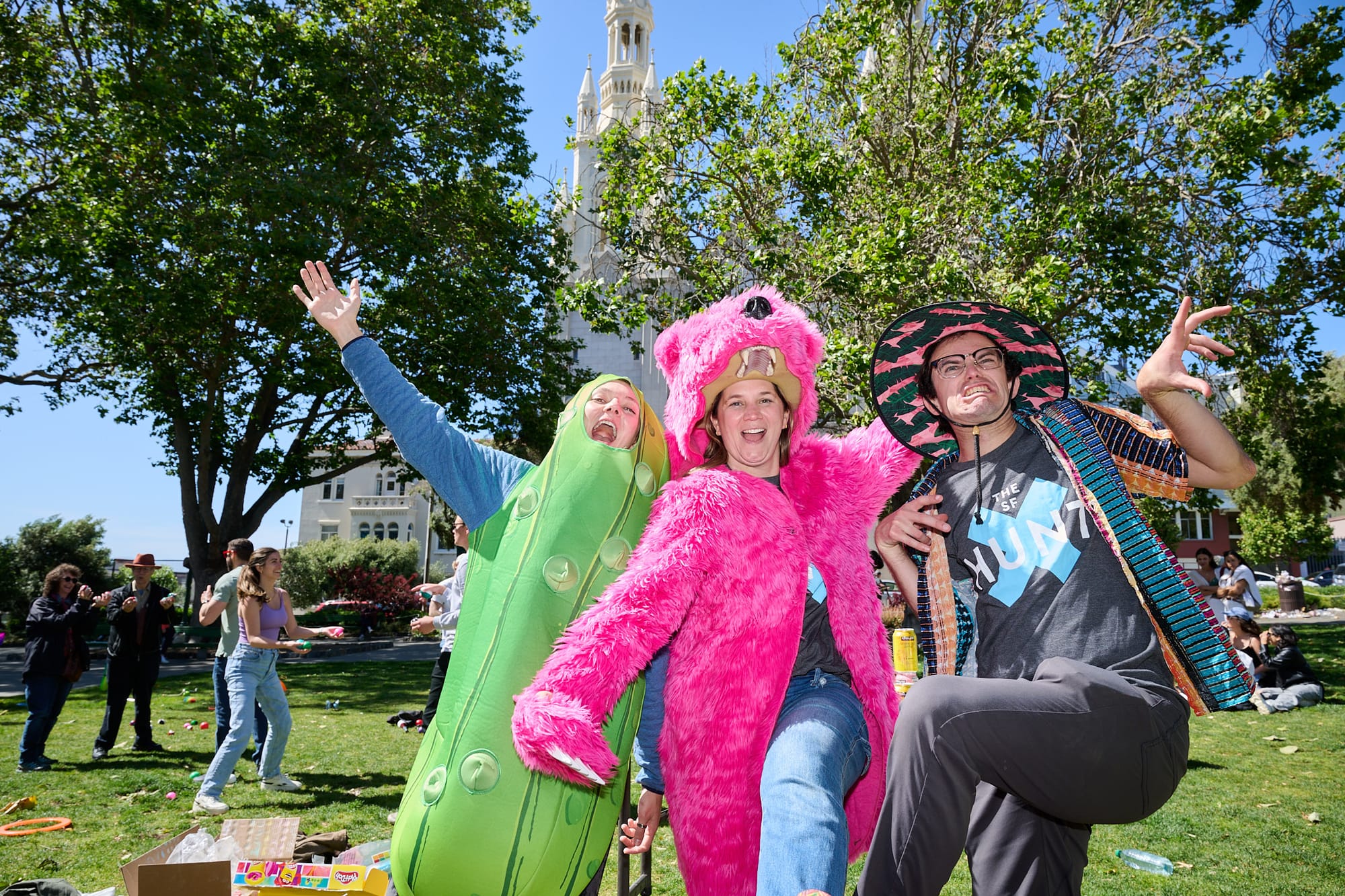 Three people in costumes making funny faces.