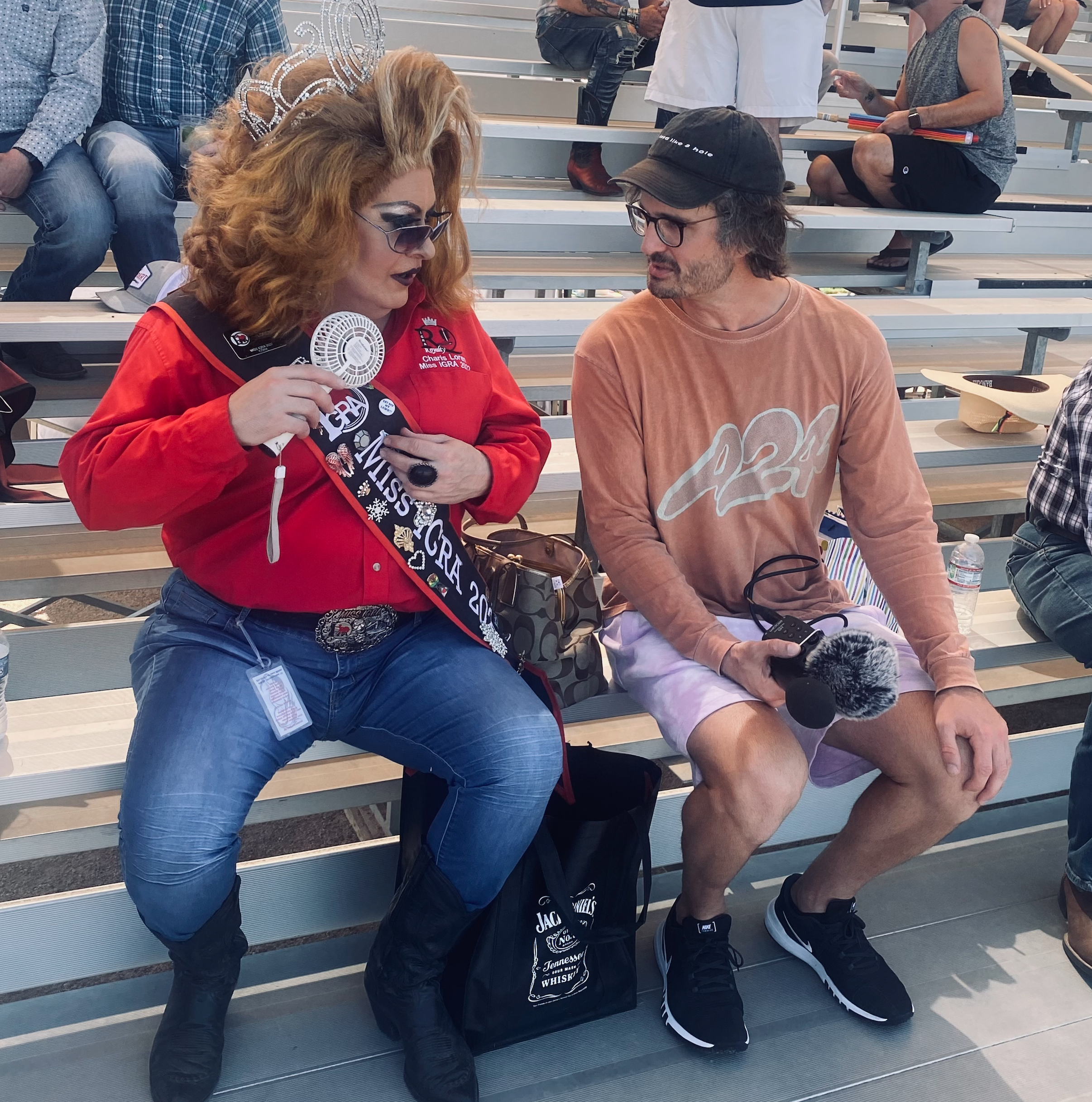 Me at a gay rodeo interviewing someone in wonderful drag!