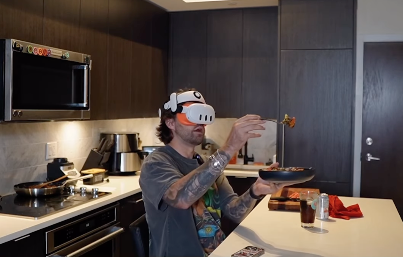 Man wearing Quest goggles in his kitchen, talking to Merv