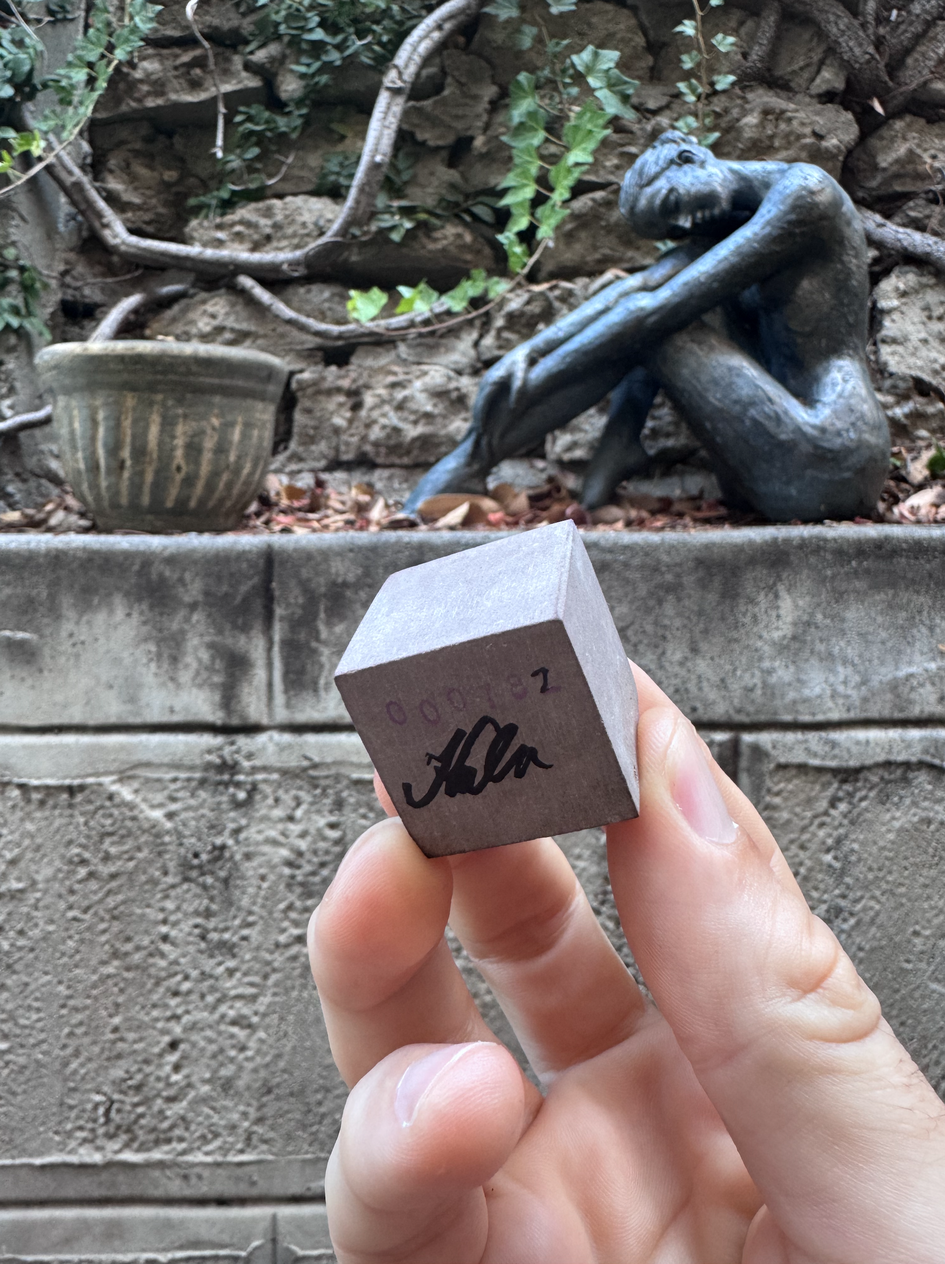 Me holding a cube of rock about 2cm by 2cm