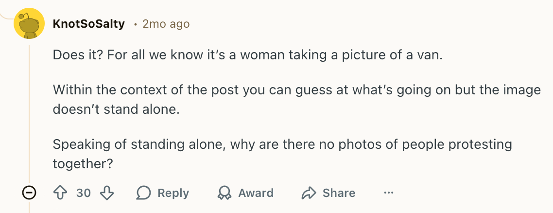 For all we know it's just a woman taking a picture of a van!