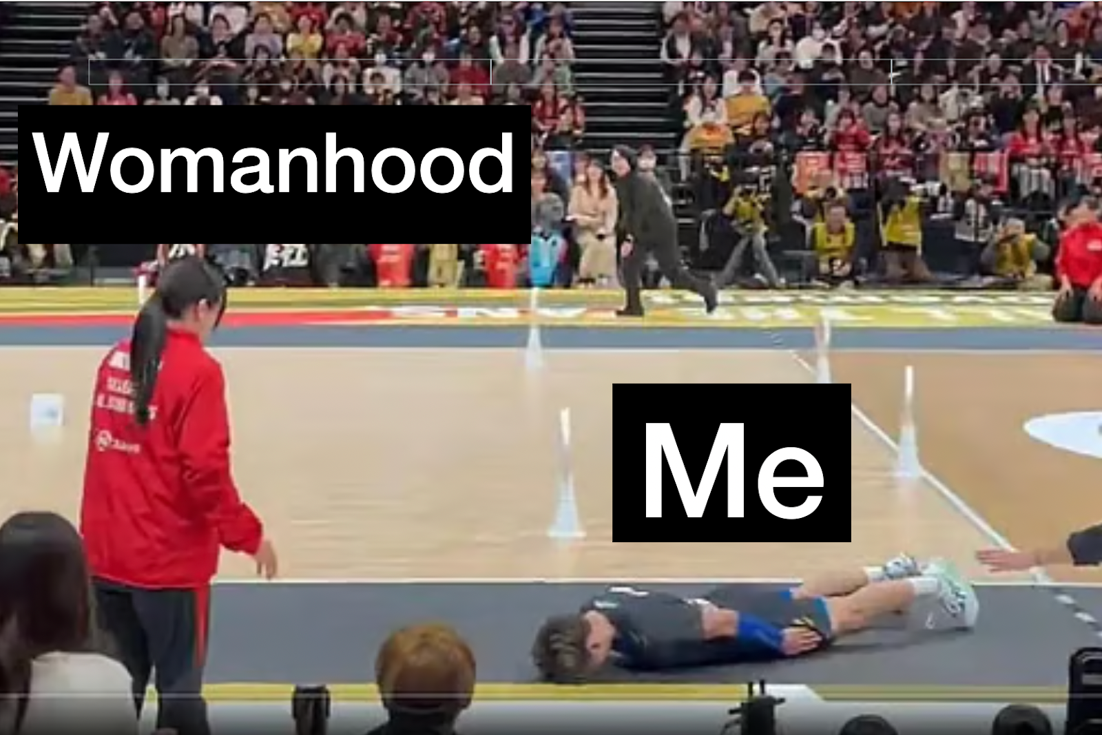 Volleyball player facedown in front of woman he accidentally hit in the head with a ball