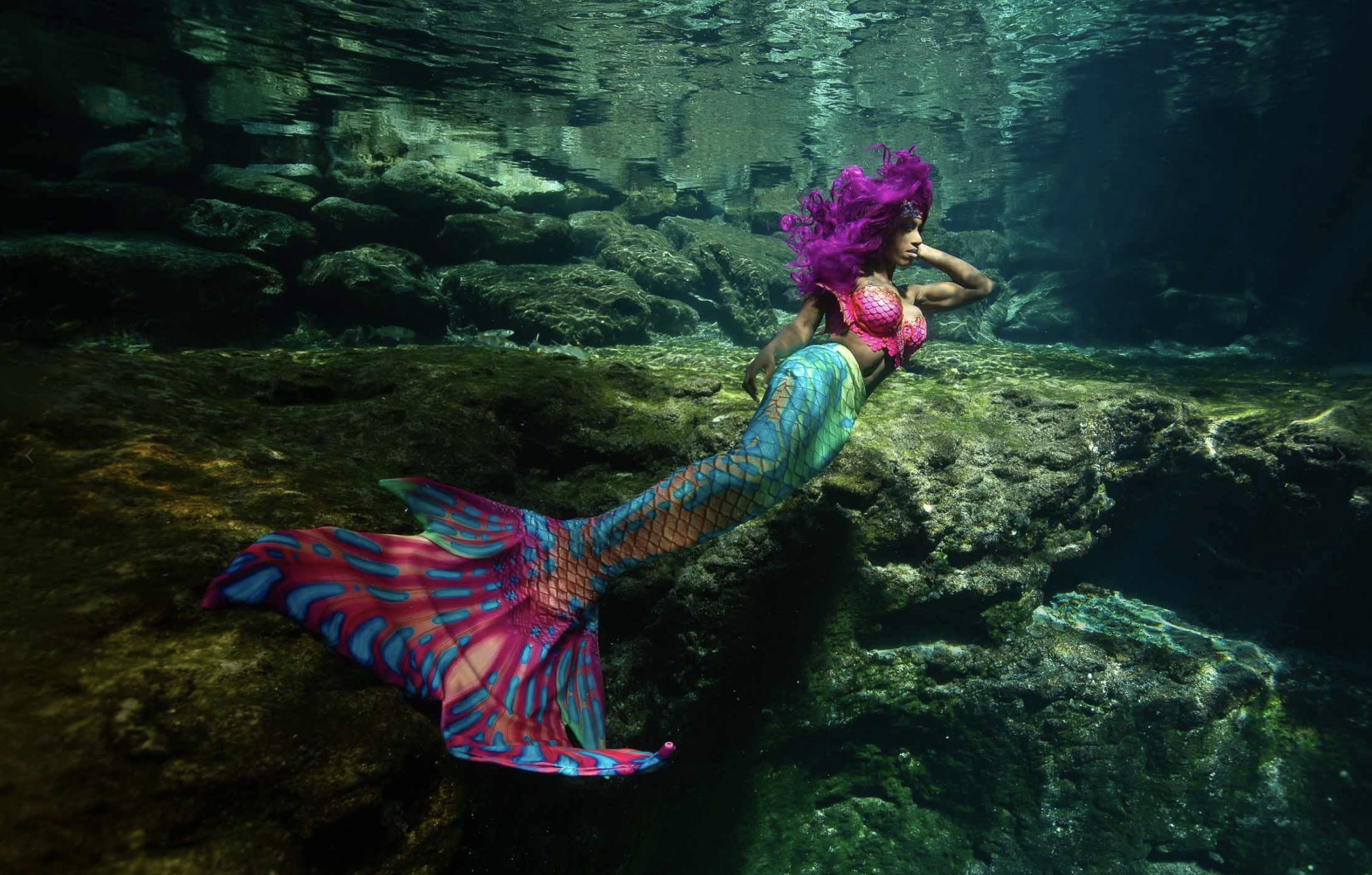 A person dressed as a mermaid underwater with full tail!