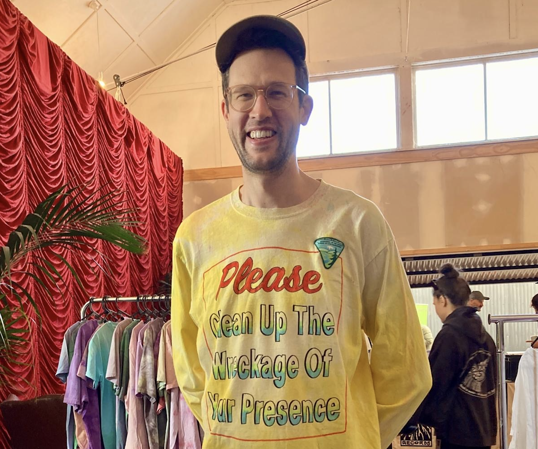 A tie dye shirt "Clean up wreckage of your presence"