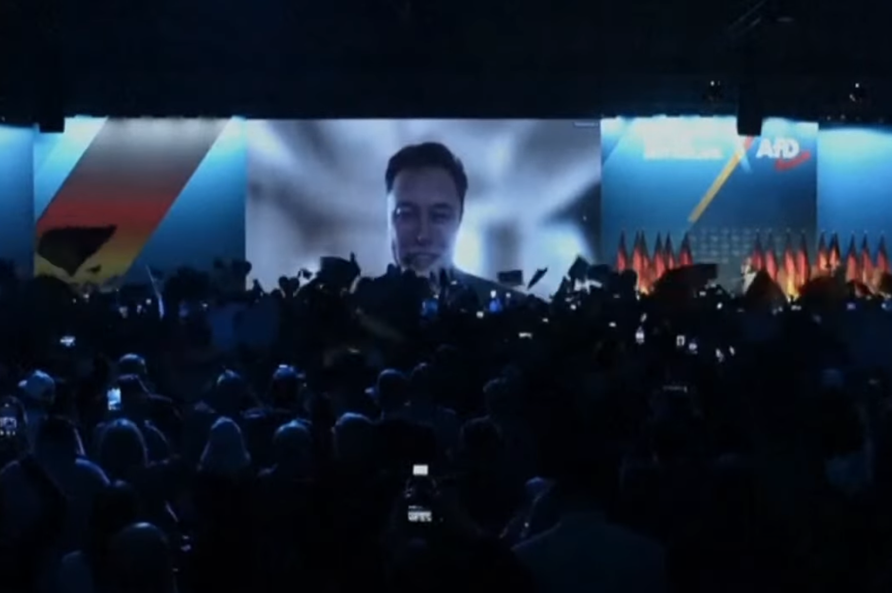 Musk beamed in over the audience on giant screens