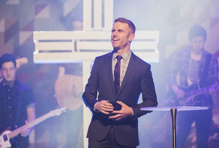 John Cameron in a suit on stage
