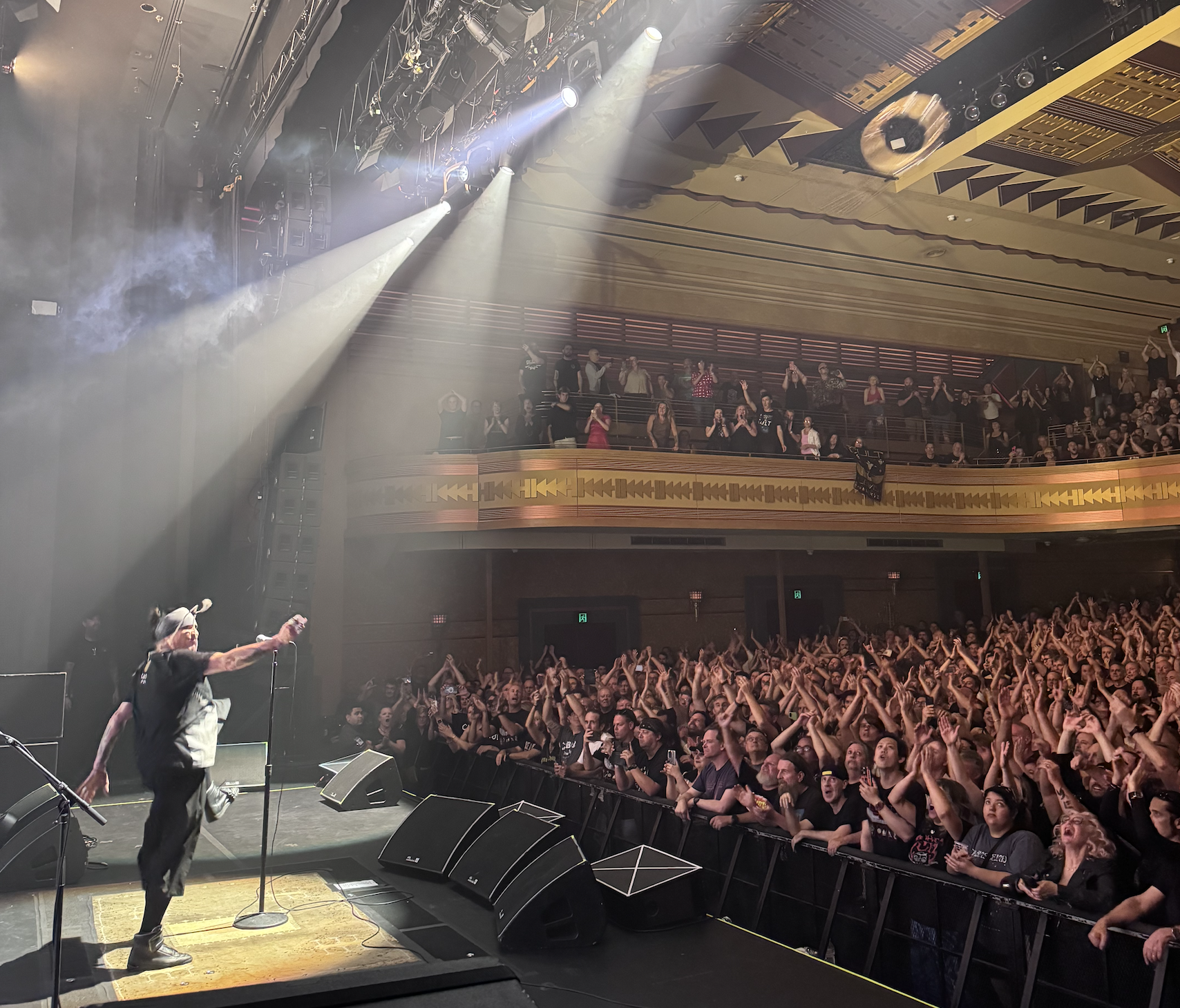 Ian throws a tambourine into the audience