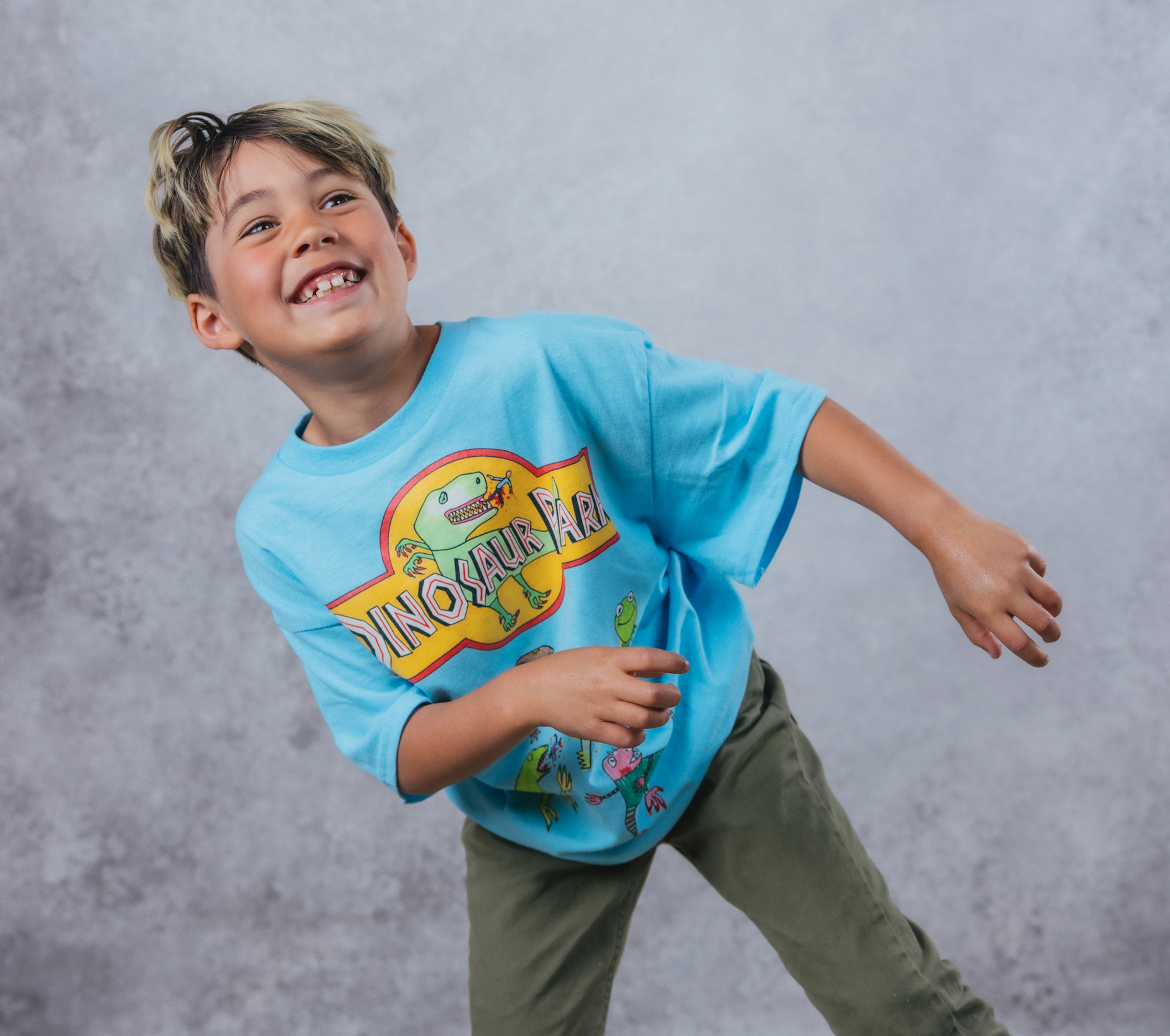 Calvin smiling, wearing a Jurassic Park tee