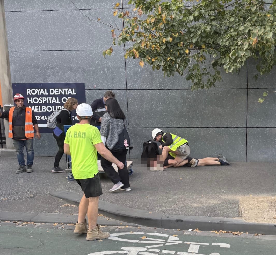Fake Seizure guy being sat on by construction workers