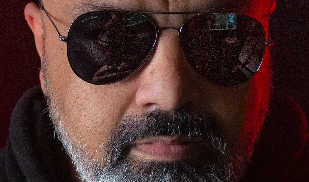 Rajneel Singh promo shot in sunglasses with greying beard