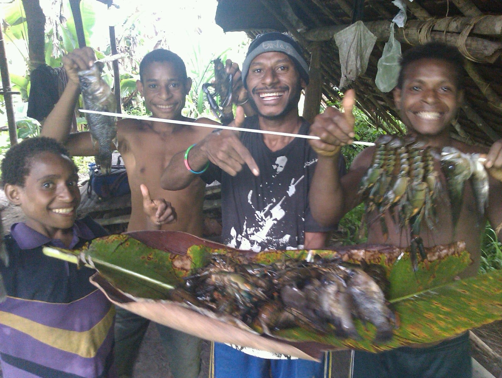 Smiling and pointing to food - a crayfish