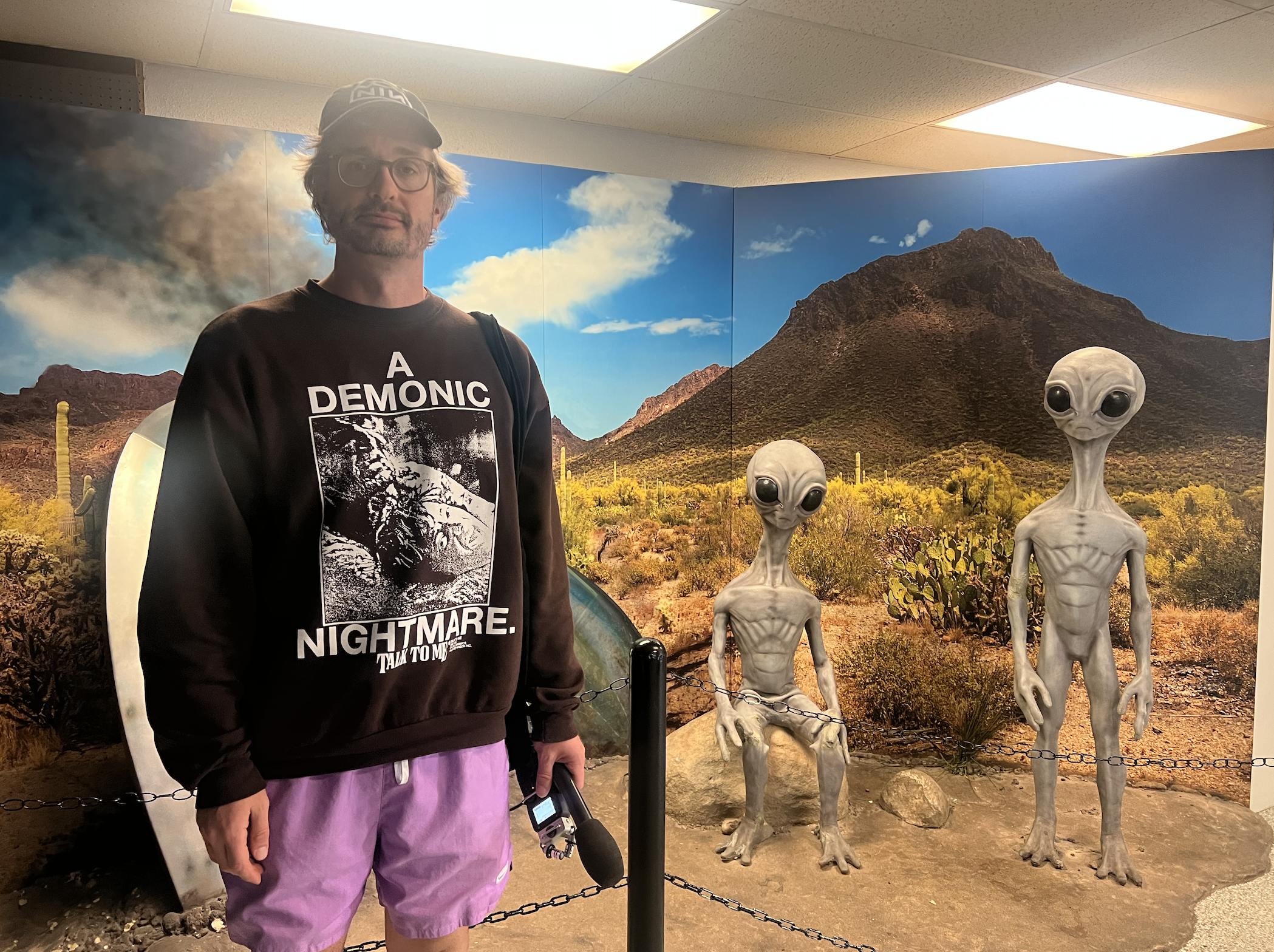 Me in front of a UFO display featuring life size alien greys