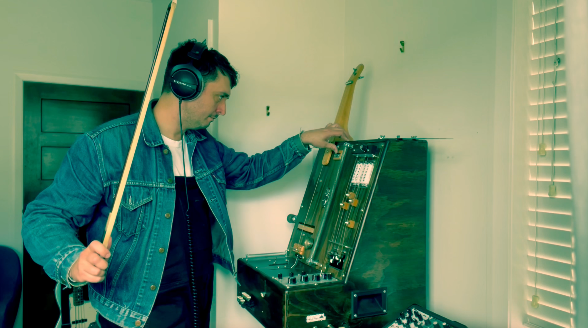 Lachlan playing strings on The Clamp with bow