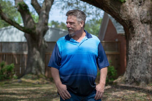 John Barnett in blue shirt