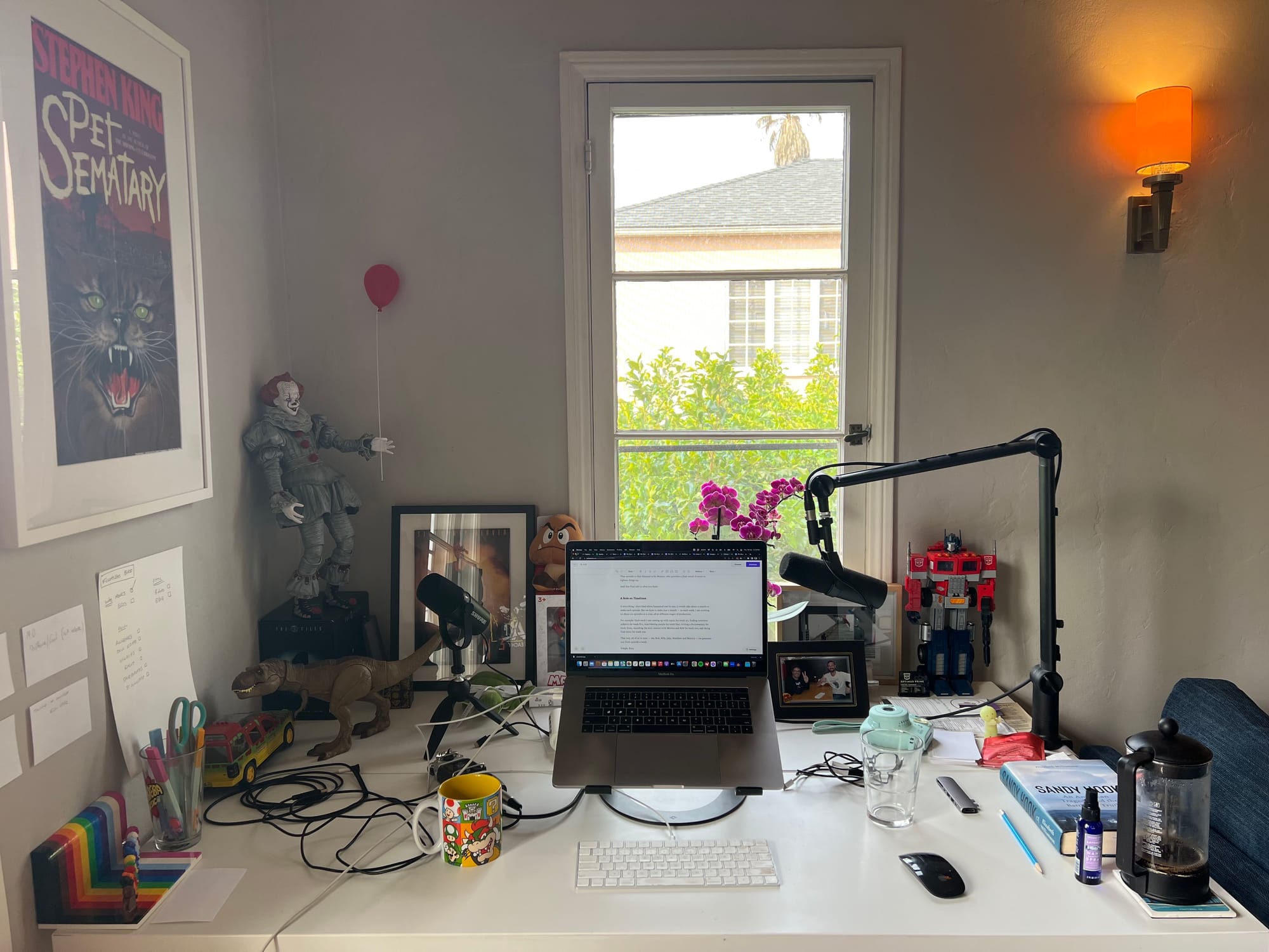 My desk with Stephen King IT clown; laptop; microphone and books and papers